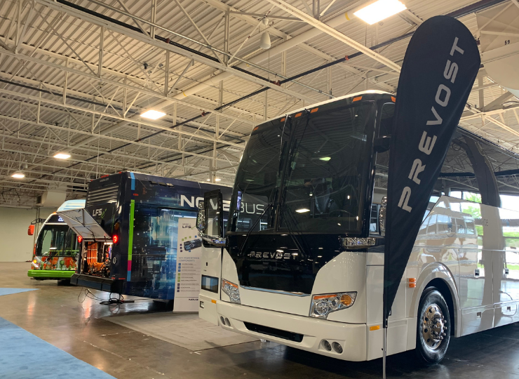 Exhibition of Prevost and Nova buses in a showroom, highlighting innovation in transportation solutions.