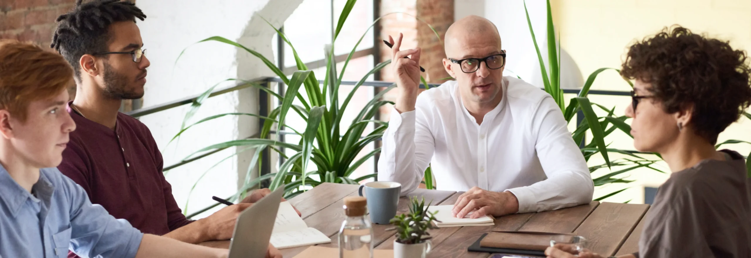 An individual in a white shirt participating in a meeting, representing modern work practices and remote communication.