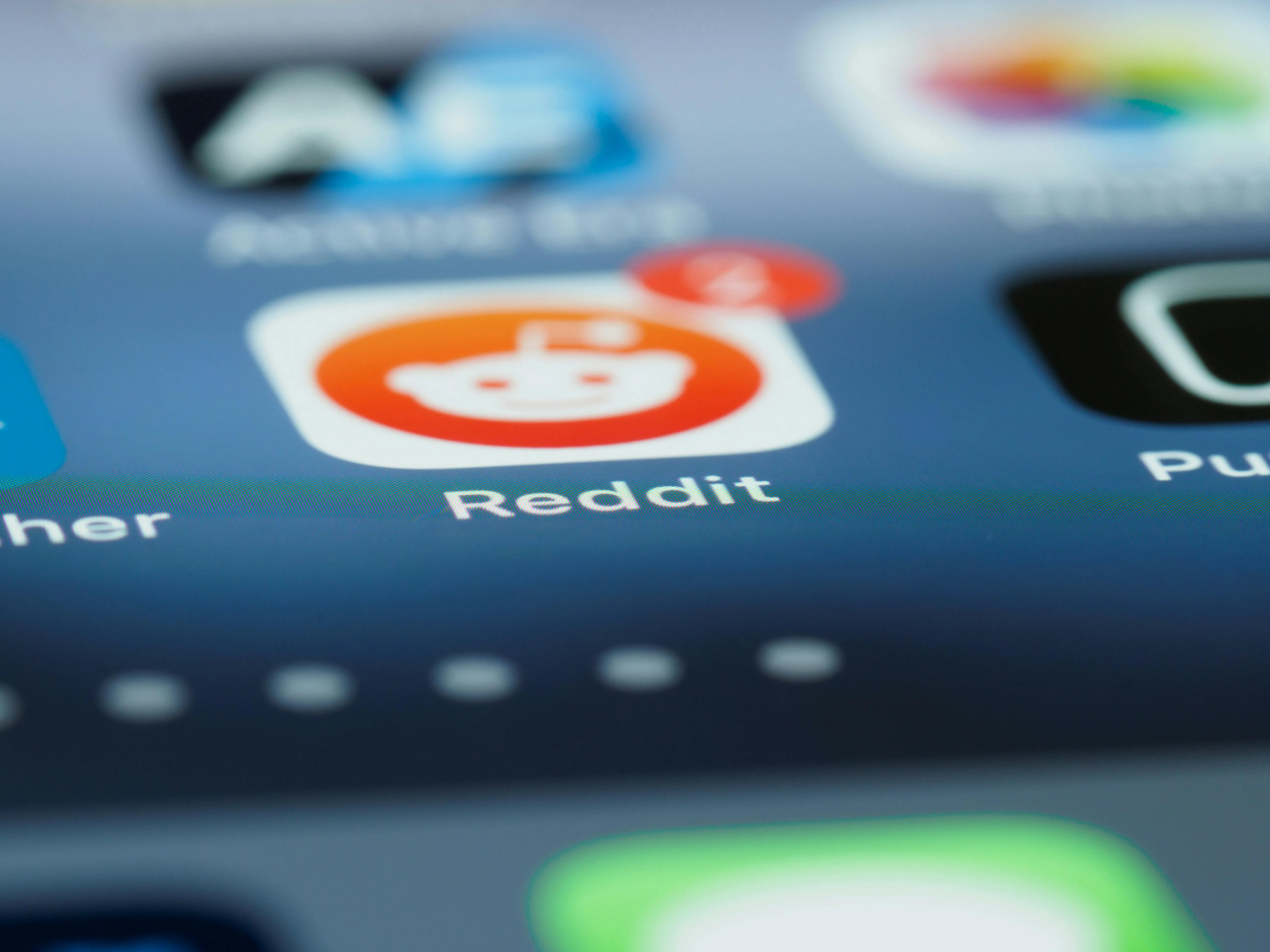 Close-up of the Reddit app icon on a smartphone screen.