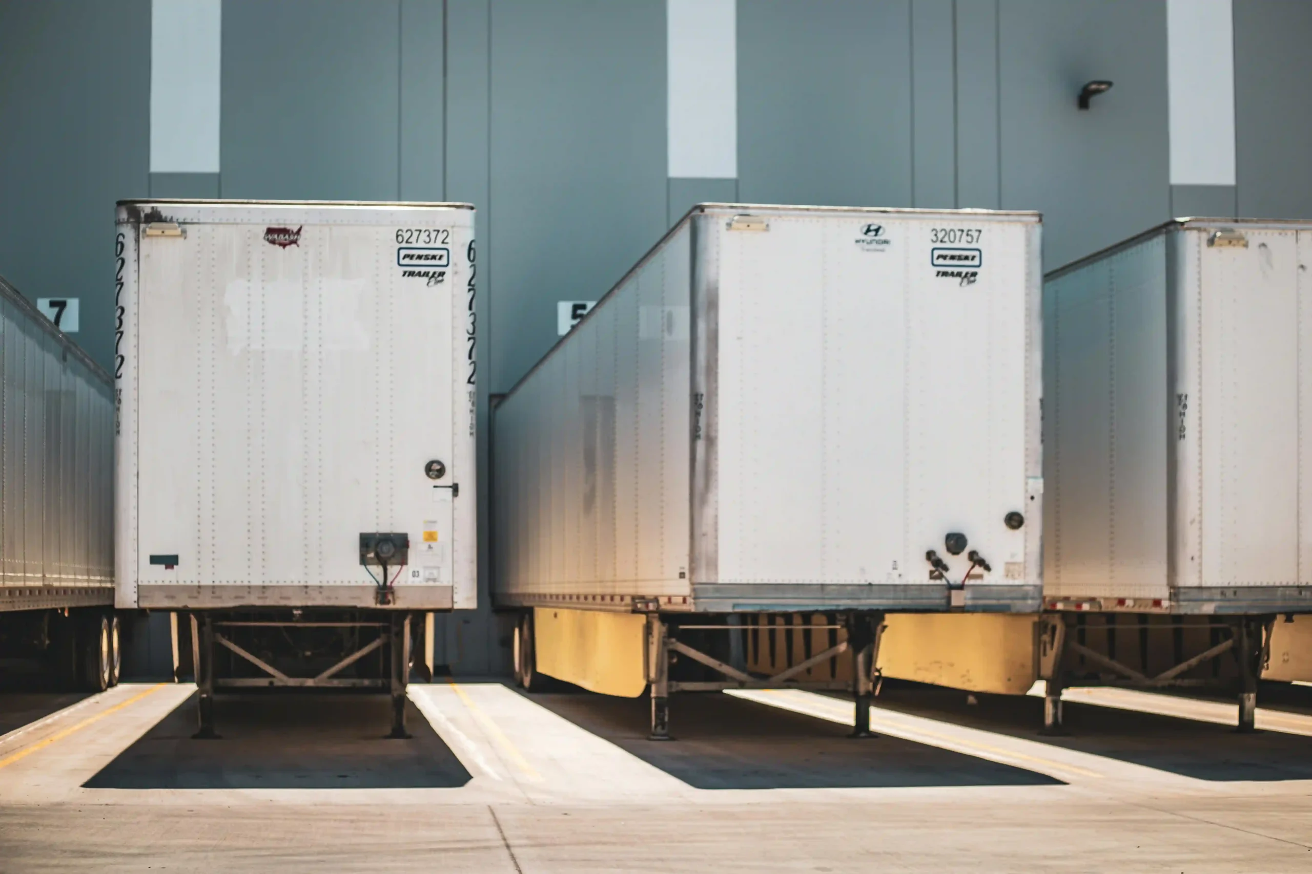 Back of a truck trailer at a warehouse loading dock.