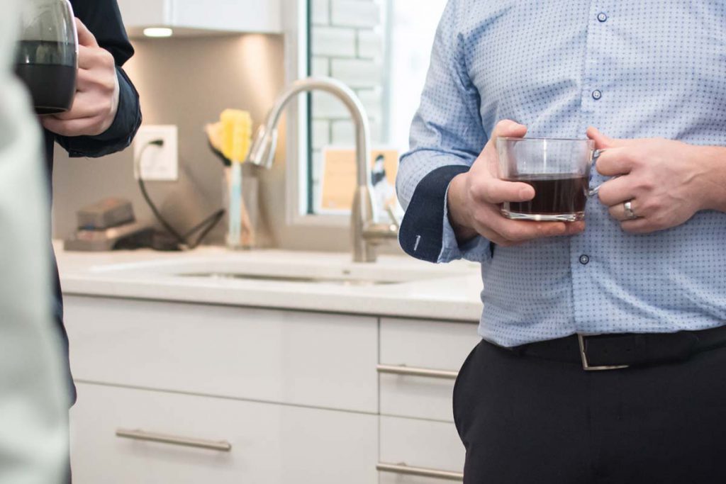 Photo of two people holding coffee mugs representing work life balance